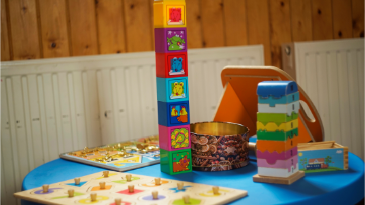 Blue table with children's toys on top.